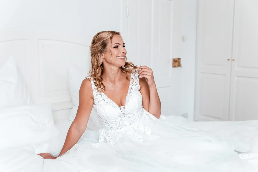 Natürliches Brautporträt im Hochzeitskleid beim Getting Ready vor der Hochzeit